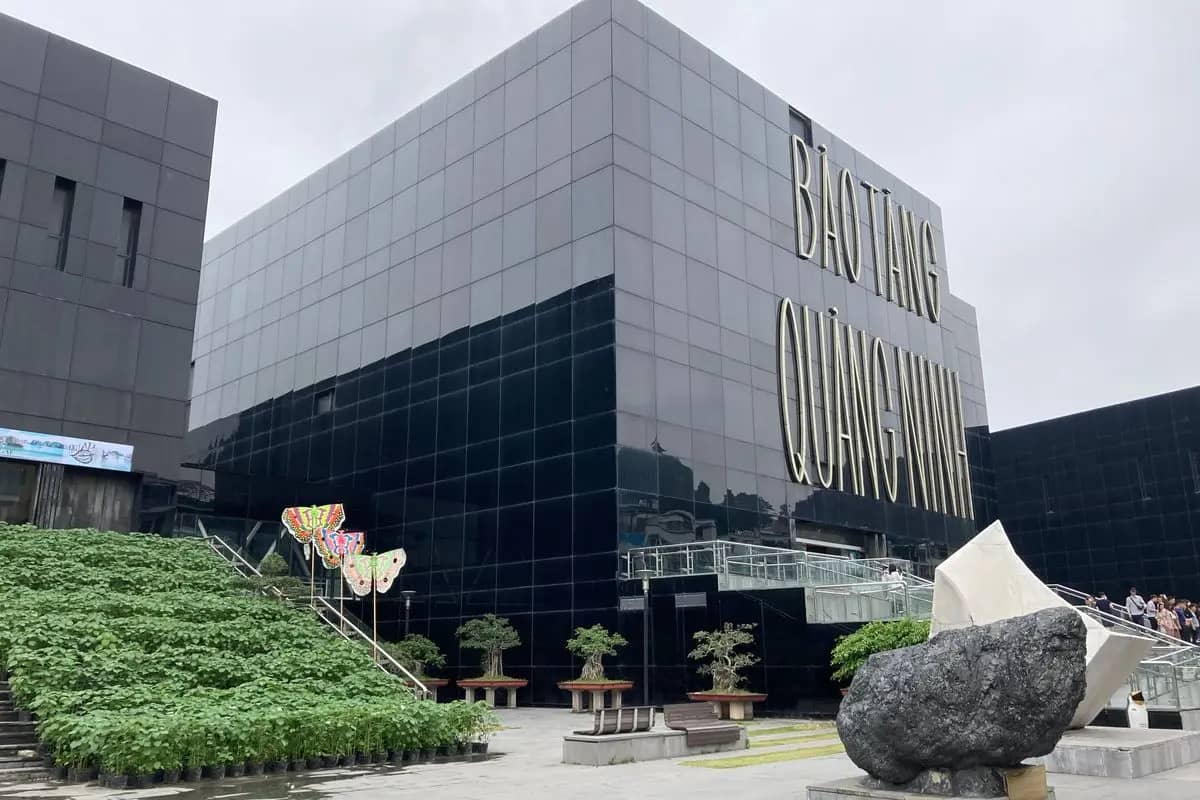 The black glass cube of the Quang Ninh Museum with its name in large letters, a lump of coal on the forecourt