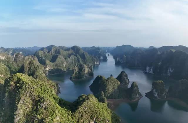 Limestone islands rising from the water of Ha Long Bay, seen from above