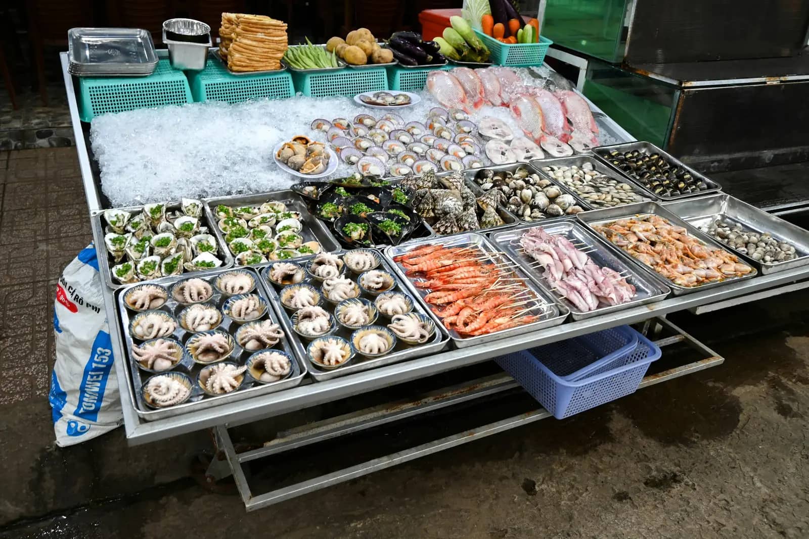 Fresh seafood laid out on ice at a market