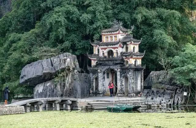 Bich Dong pagoda's gate below limestone karsts and forest in Ninh Binh