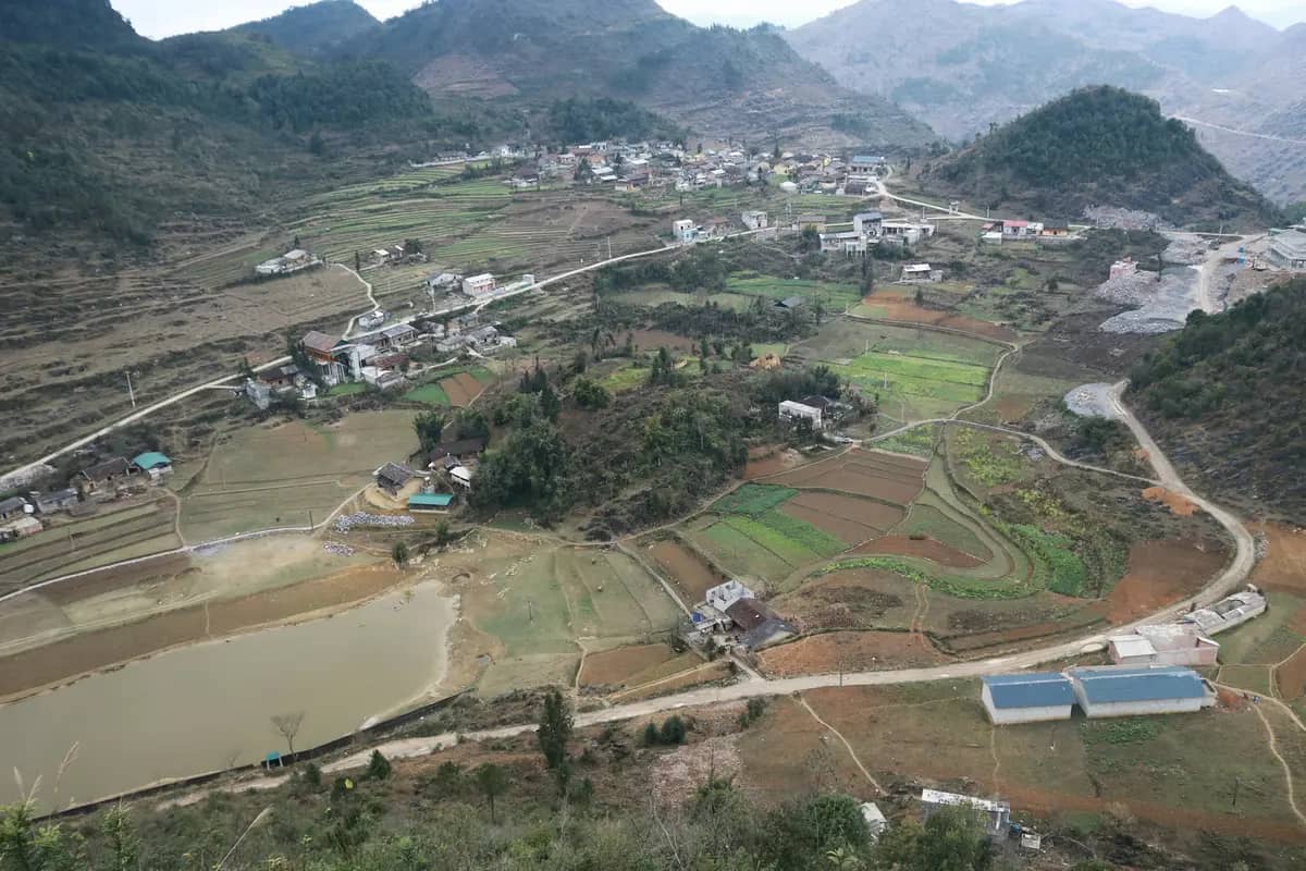 A village, its fields and a pond at the foot of Dragon Mountain, seen from the Lung Cu flag tower