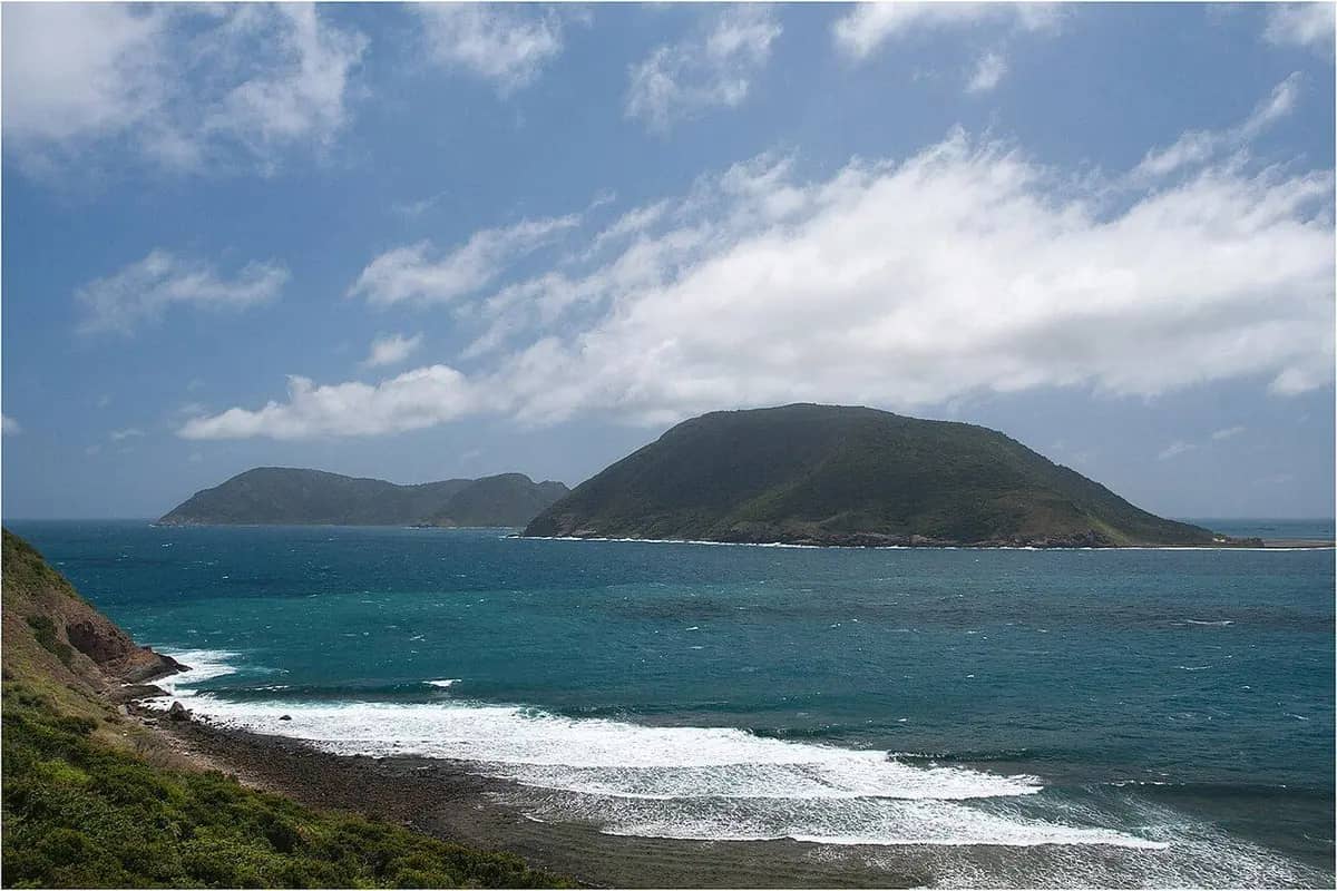 Bay Canh island across the sea from Con Son, waves breaking on the rocks below