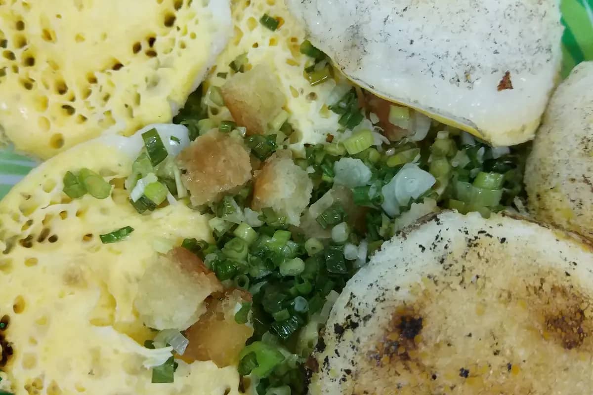 Banh can, small rice cakes cooked in clay moulds, topped with spring onion