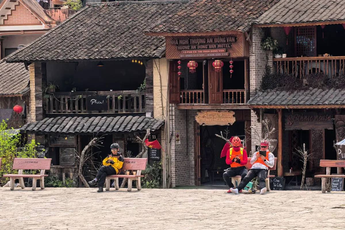 Old two-storey houses with tiled roofs and wooden balconies on the stone square of Dong Van old town
