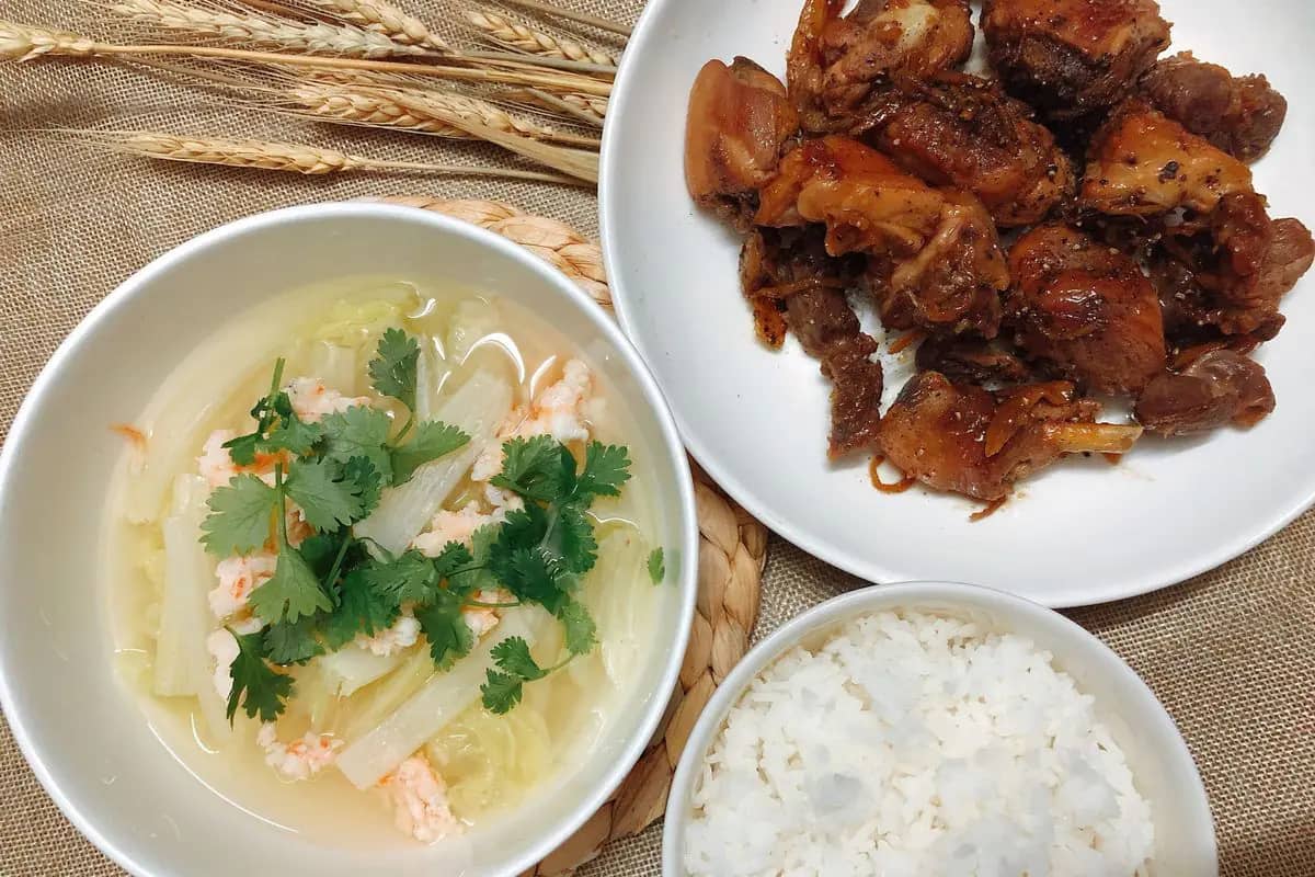 A simple Vietnamese lunch of braised pork, a bowl of soup and white rice