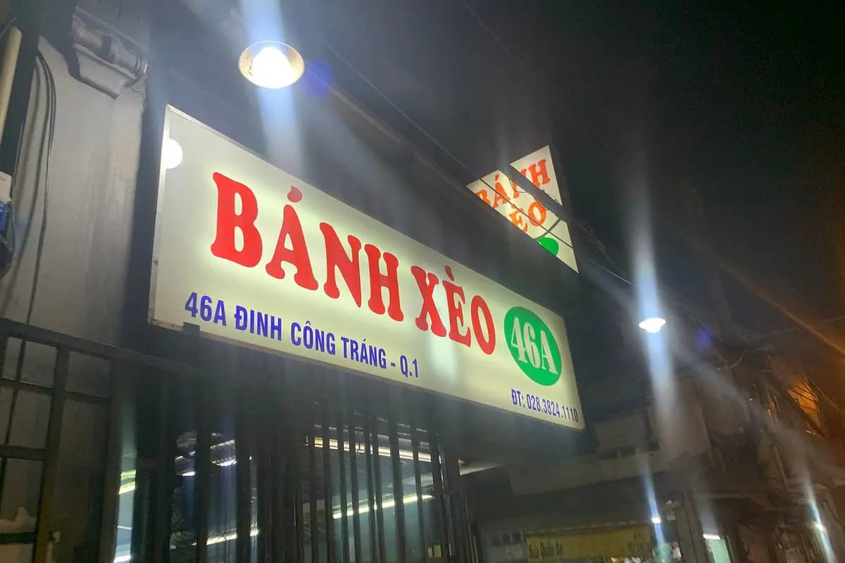 The lit sign of Banh Xeo 46A on Dinh Cong Trang Street at night
