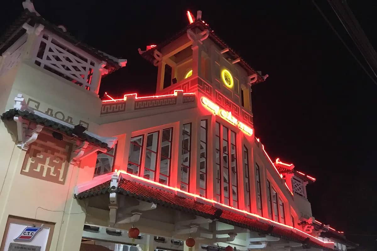 The old market building in Can Tho lit up in red at night
