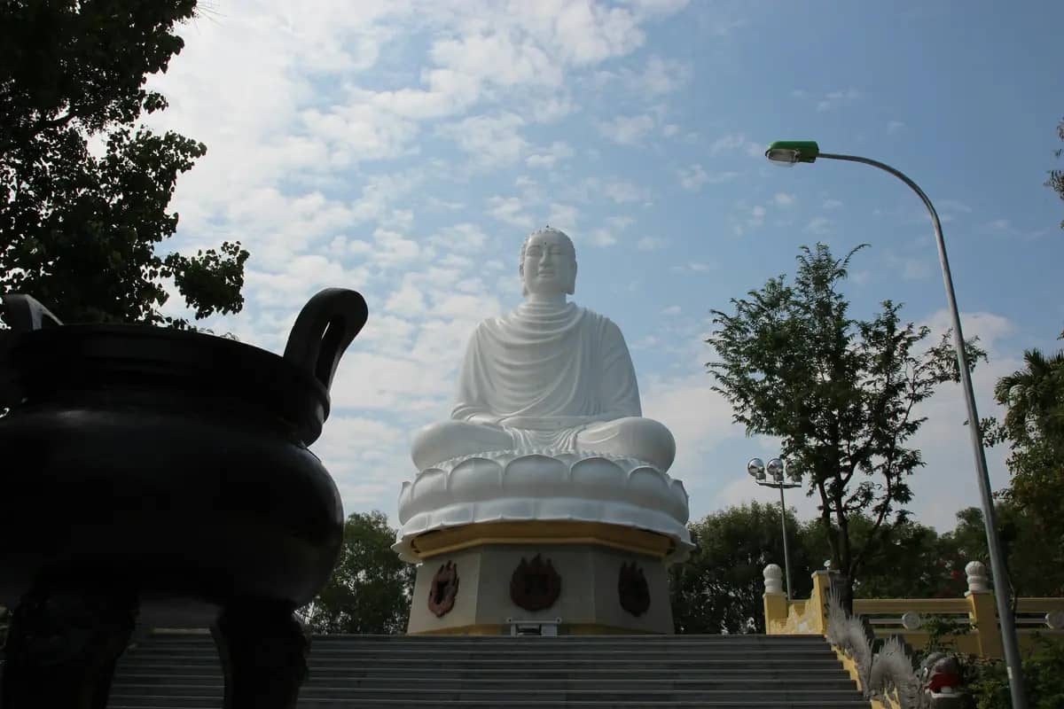 The white seated Buddha on its lotus base above the steps at Long Son Pagoda