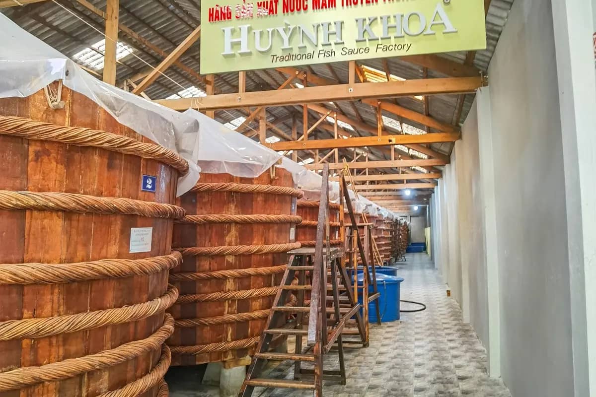 Big wooden barrels of fermenting fish sauce inside a fish sauce house on Phu Quoc