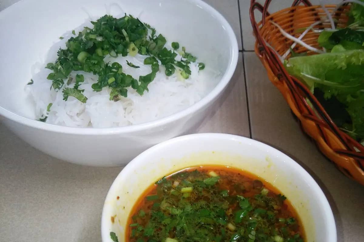 Bun quay: a bowl of rice noodles with herbs and the bowl of sauce you stir in yourself