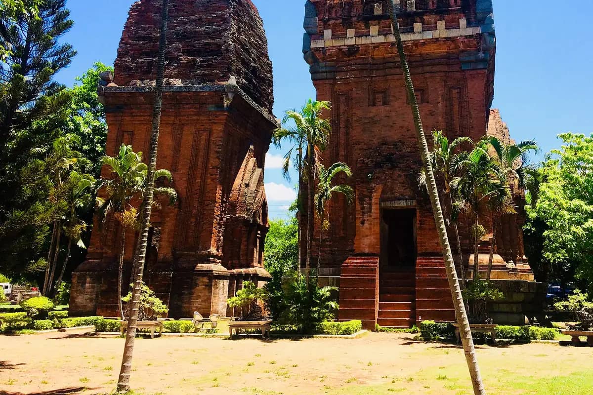 The two brick Cham towers of Thap Doi among palm trees in Quy Nhon