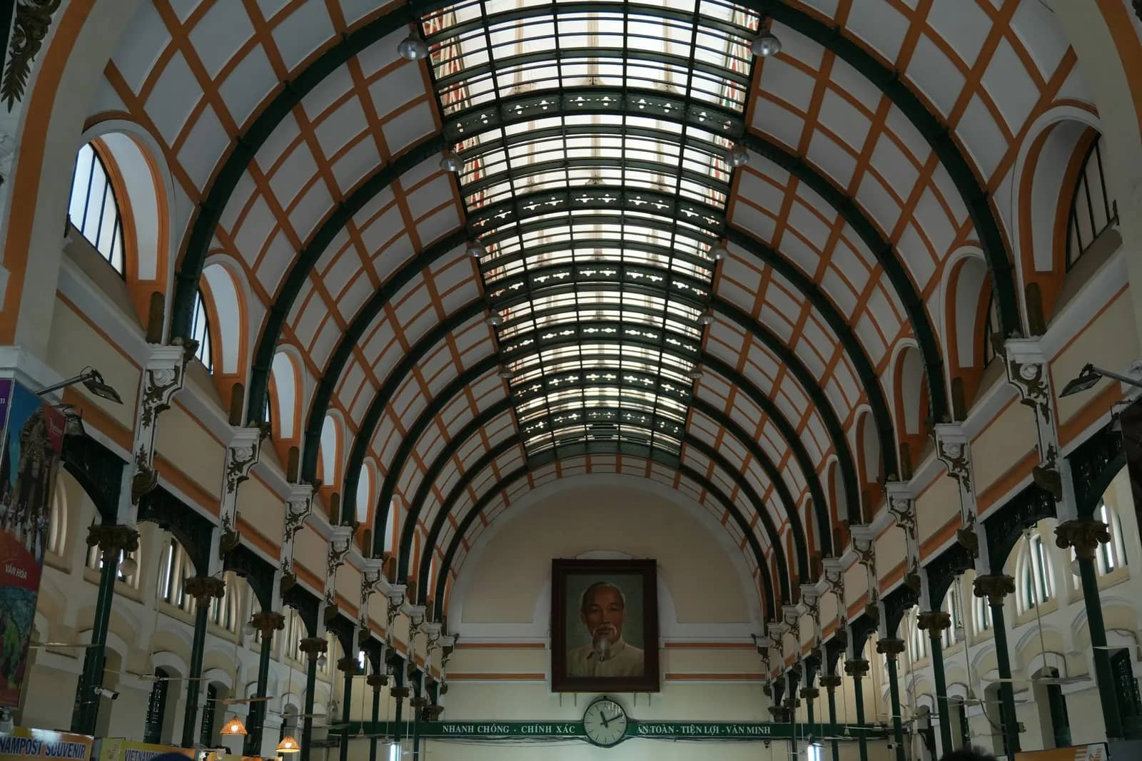 Inside the Central Post Office: the arched hall under its skylight, a portrait at the far end