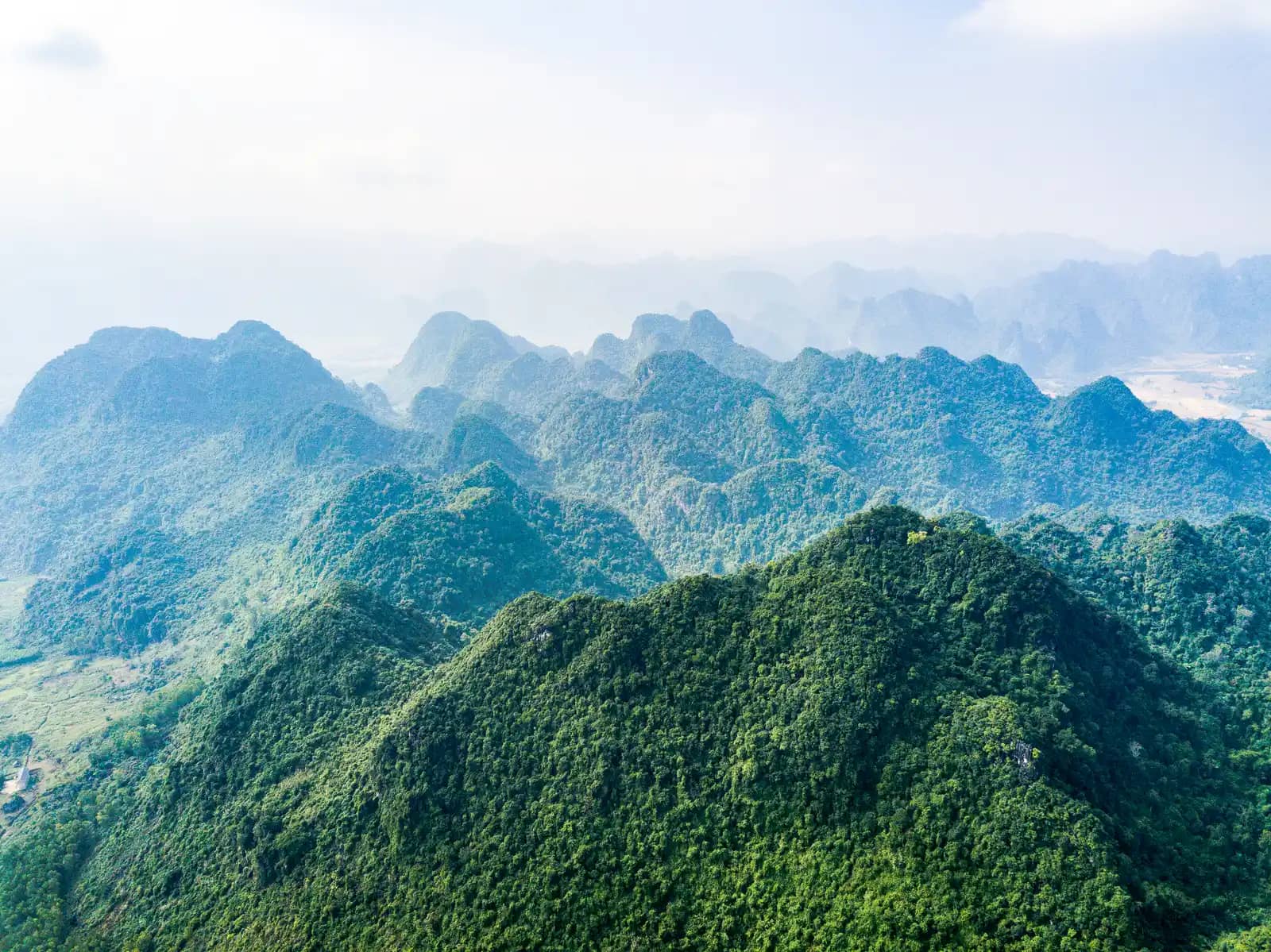 Aerial view of forested limestone peaks in Phong Nha-Ke Bang National Park in haze (the park around Dark Cave, not the cave itself)