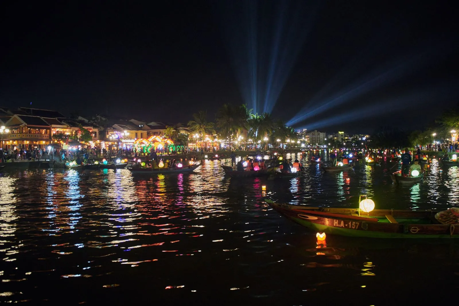 Lantern-decorated boats on the Thu Bon River during the Hoi An Lantern Festival at night