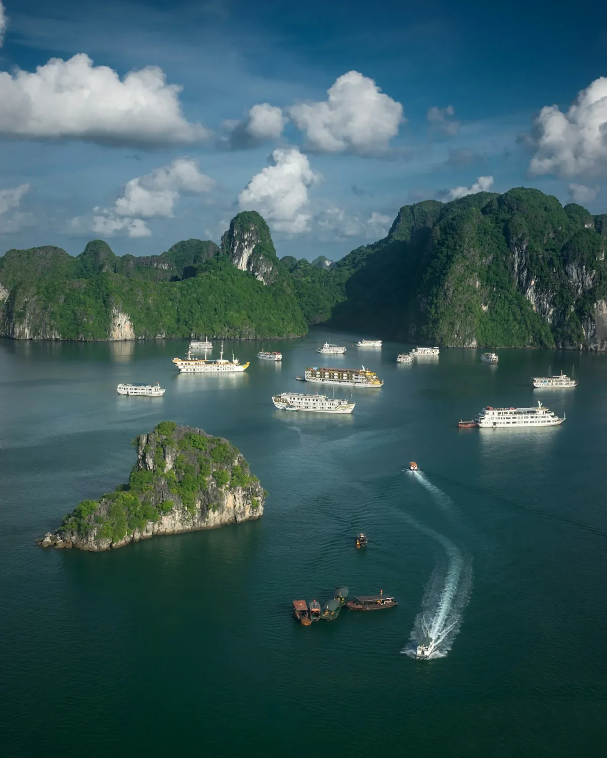 Ha Long Bay seen from the Ti Top Island viewpoint, cruise boats scattered among green limestone islets