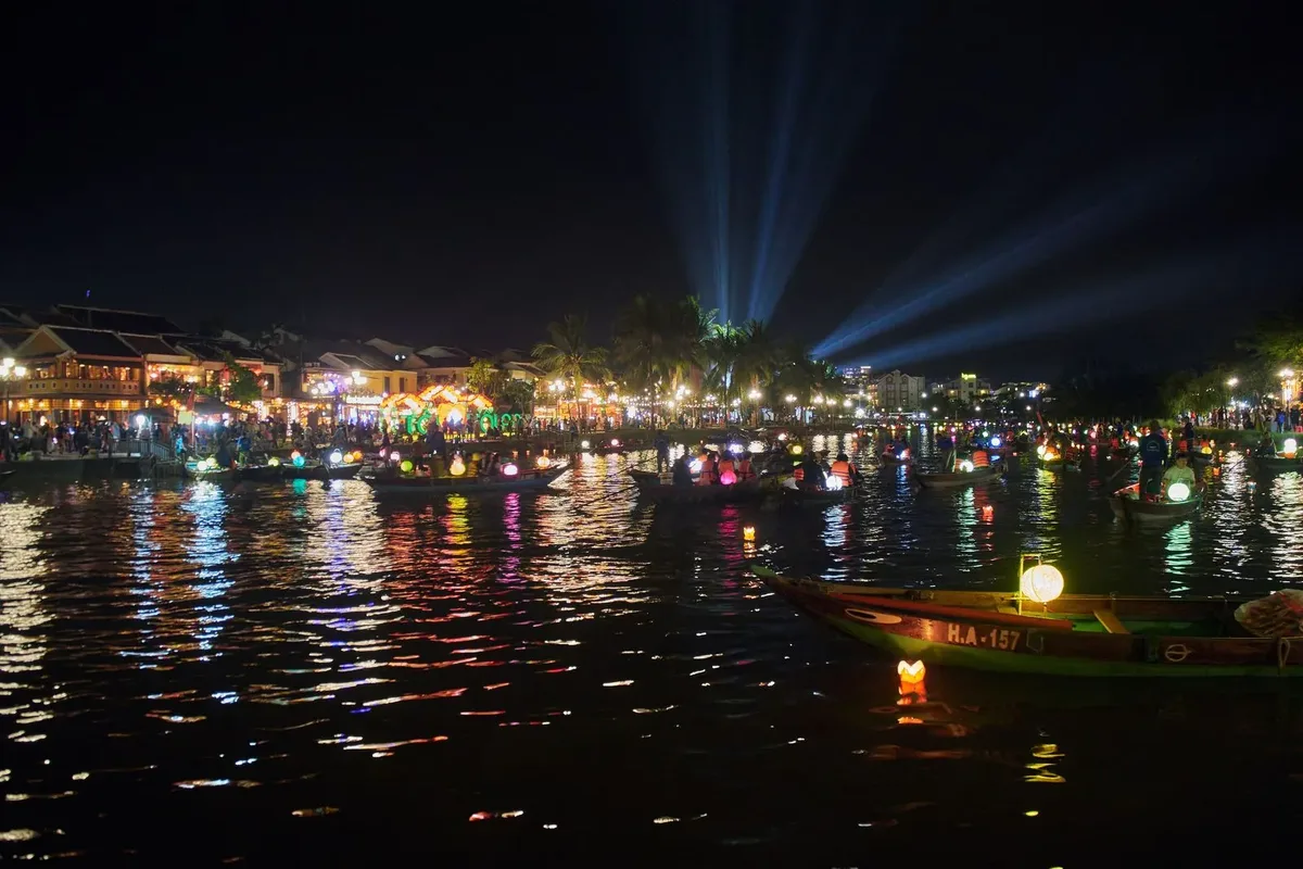 Lantern-decorated boats on the Thu Bon River during the Hoi An Lantern Festival at night
