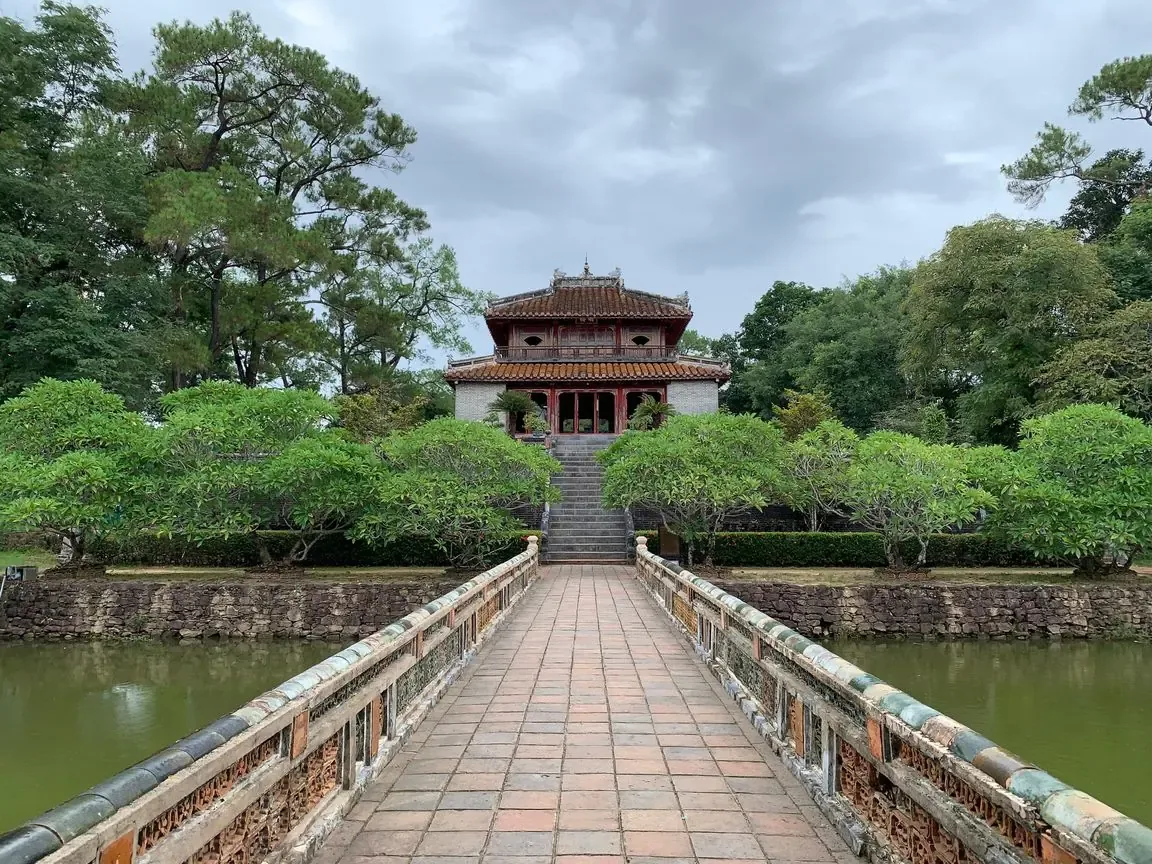 Minh Lau pavilion at the tomb of Emperor Minh Mang, reached by a long bridge across a pond
