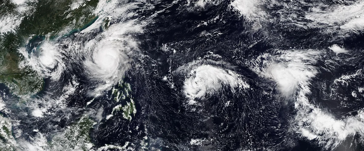 Four tropical cyclones side by side over the West Pacific in one satellite image, from the Vietnam coast eastward