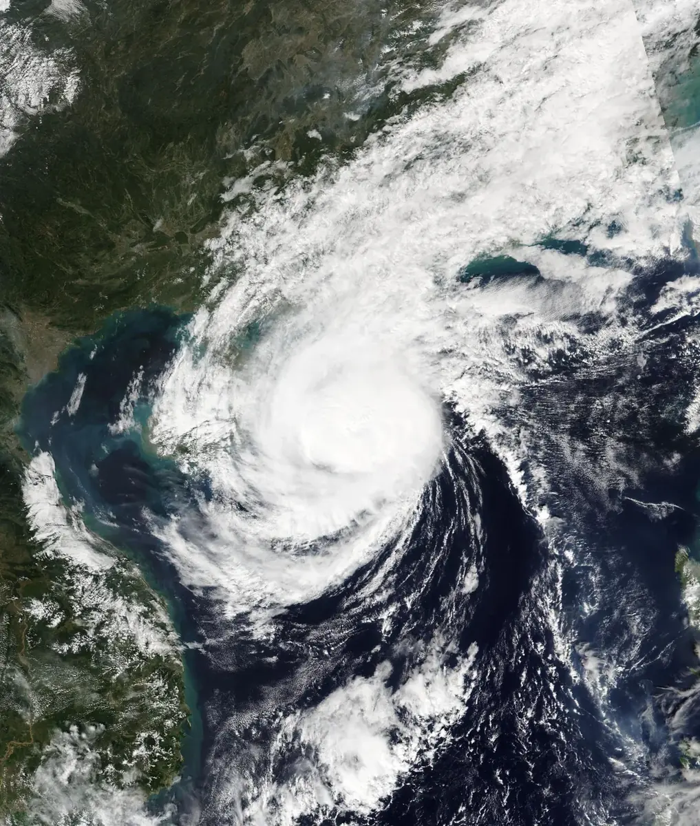 Satellite view of Typhoon Yinxing, a white spiral of cloud over the South China Sea off Vietnam's coast
