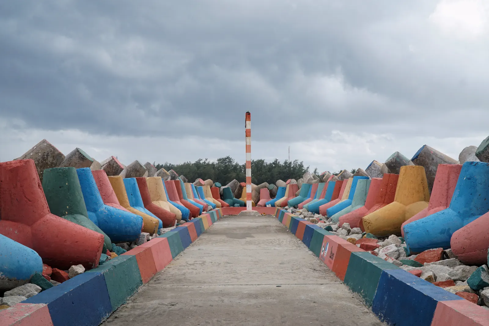 A jetty on Phu Quy lined with concrete tetrapods painted red, blue, green and yellow