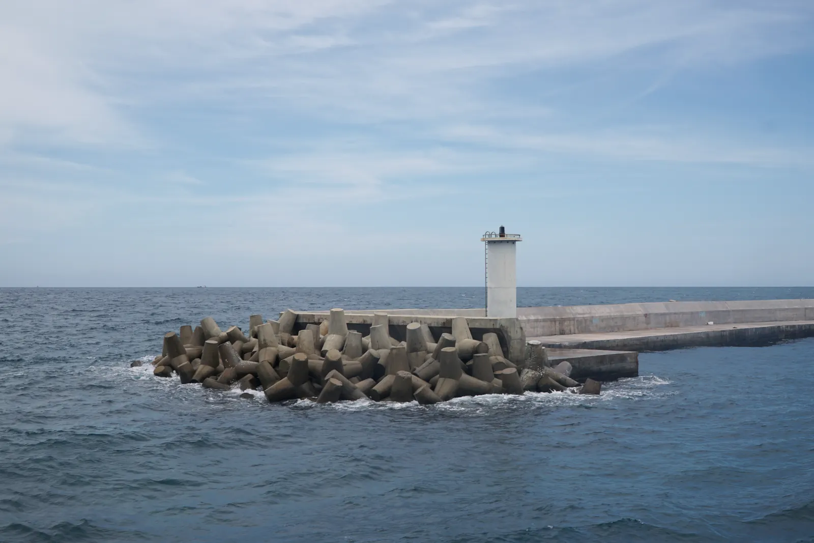A navigation light at the end of a tetrapod breakwater on Phu Quy