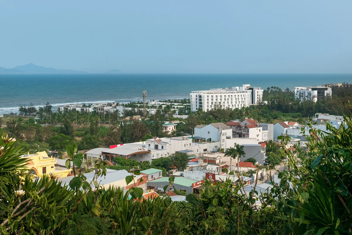 View from the Marble Mountains over low houses and hotels to the sea and a long beach