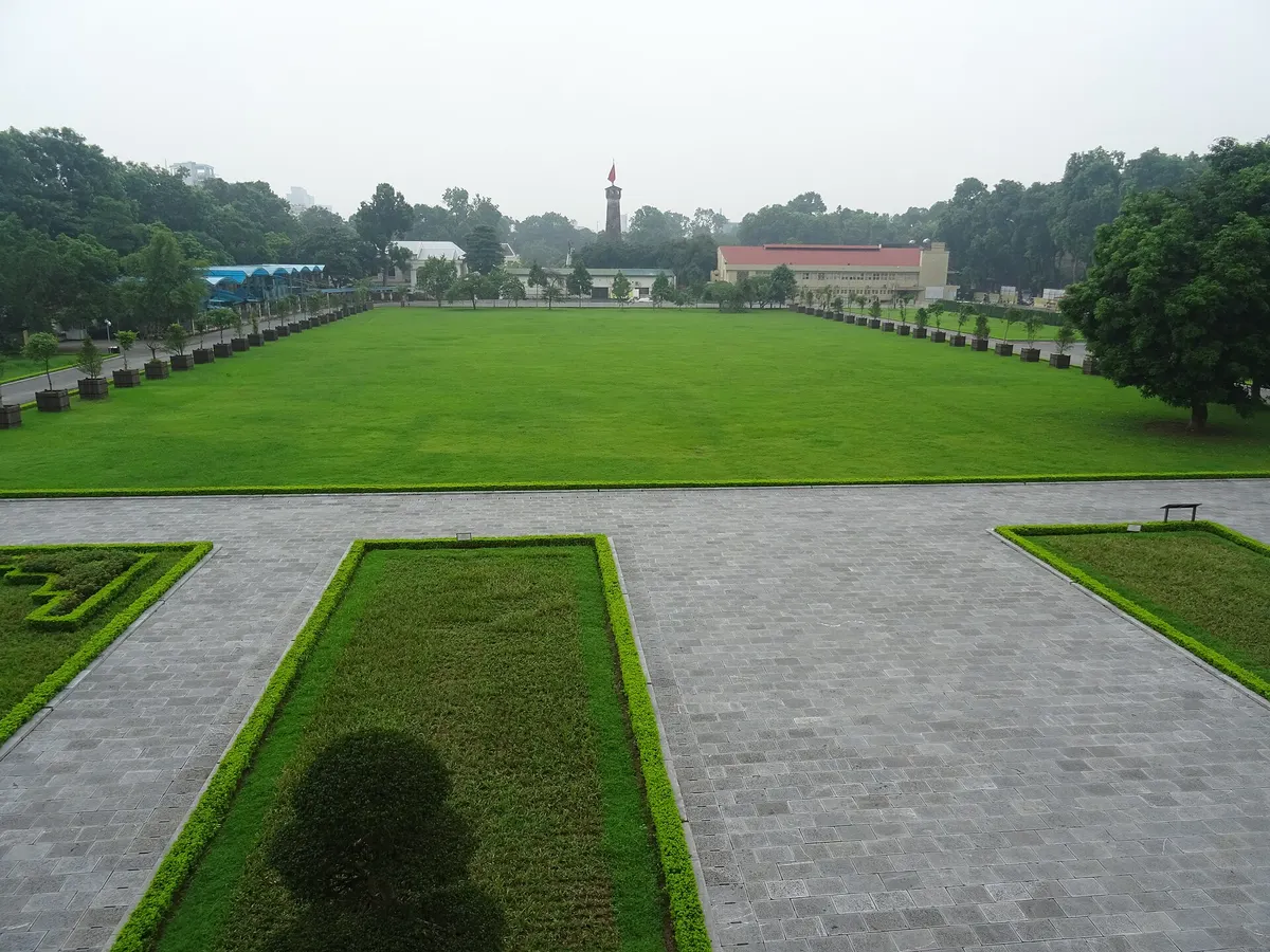 Looking south from Doan Mon across a long lawn toward the Hanoi Flag Tower