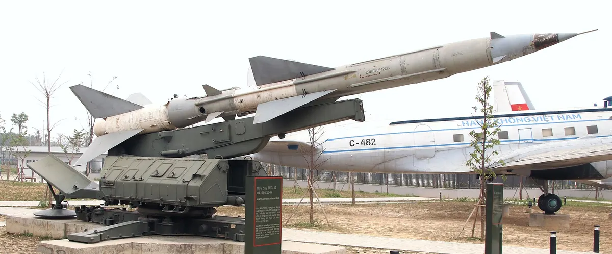 An SA-2 missile on its launcher in the museum's outdoor display, an aircraft behind