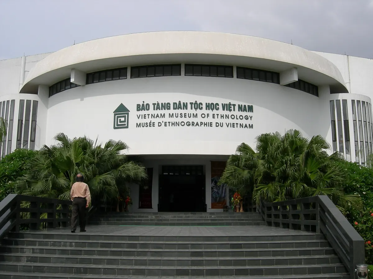 The museum's curved white entrance building with its name in Vietnamese, English and French above the steps