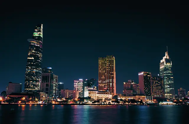 Ho Chi Minh City skyscrapers lit at night across the Saigon River