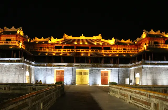 Imperial City pavilions in Hue lit gold against the night sky